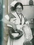 Nursing Student Carrying Bedpan and Other Equipment by Misericordia University